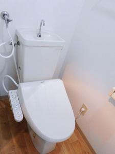 a bathroom with a white toilet with a sink at メープル桑園駅202 in Sapporo +8 photos