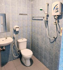 a bathroom with a shower and a toilet and a sink at Hotel Seri Nilai in Nilai +35 photos