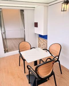 a dining room with two chairs and a table at Kea Garden Guest House in Brinchang