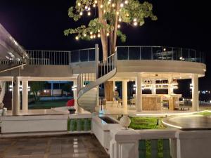 a large house with a staircase in front of it at Suntara Wellness Resort & Hotel in Chachoengsao