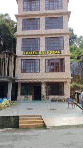 a building with a hotel in front of it at Hotel Sai Kripa, sikkim in Ravangla