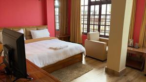a bedroom with a bed and a tv in it at Hotel Sai Kripa, sikkim in Ravangla