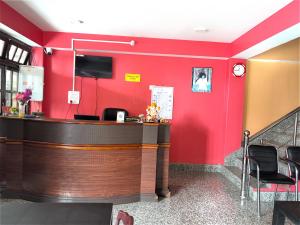 a bar in a restaurant with red walls at Hotel Sai Kripa, sikkim in Ravangla +15 photos