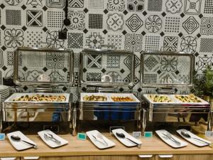 a buffet with several trays of food on display at ibis Styles Bialystok in Białystok +142 photos