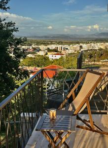a table and chairs on a balcony with a view at Glass house in Ulcinj