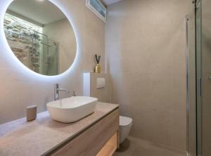 a bathroom with a sink and a mirror and a toilet at Apartman Dolce in Trpanj +26 photos