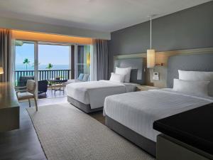 a hotel room with two beds and a balcony at Pullman Phuket Panwa Beach Resort in Panwa Beach +206 photos