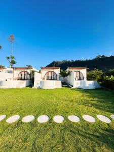 a group of frisbees on the grass in front of a house at Garden Hill Kintamani with Natural Hot Springs in Kubupenlokan