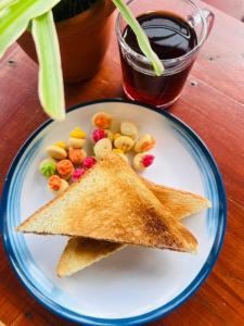 a white plate with two slices of toast and snacks at Attic Hotel in George Town +26 photos