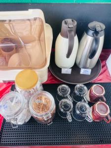 a drawer with a tea kettle and other food items at Attic Hotel in George Town