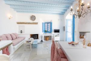 a living room with a couch and a table at Belogna Ikons in Vívlos