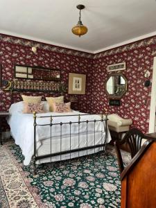 a bedroom with a bed and a table and a mirror at Munroe Inn Boutique Hotel in Auburn +17 photos