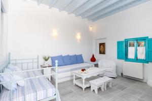 a living room with a blue couch and a table at Belogna Ikons in Vívlos +232 photos