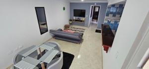 a living room with a couch and a table at Apartamento con terraza - Kalimalake in Darién
