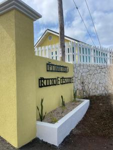 a building with a sign in front of a wall at The Chill Spot in Mo Bay in Crooked River