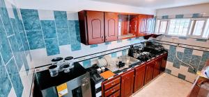 a kitchen with red wooden cabinets and a sink at Apartamento con terraza - Kalimalake in Darién