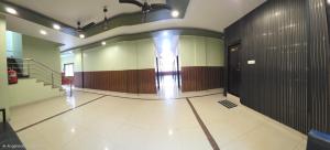 a hallway of a building with a door and a staircase at Hotel Balaji Inn in Raipur