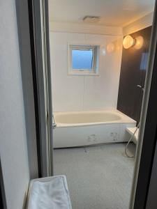 a bathroom with a bath tub and a window at Gold rich 2 in Asahikawa +47 photos