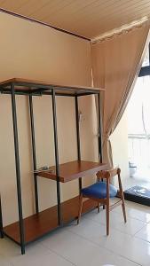 a desk and a chair in a room at Blue Rose Resort & Dive Center in Pattimura Airport