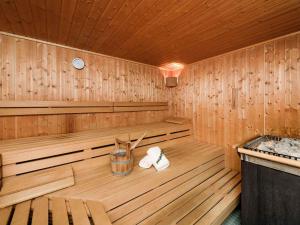 a wooden sauna with two towels in it at Sunday Hotel München Airport Freising in Freising