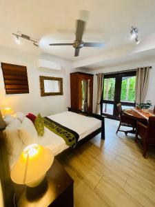 a bedroom with a bed and a table and a desk at Karinya in Clifton Beach +37 photos
