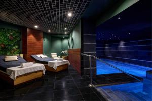 a bedroom with two beds and a swimming pool at Grand Hotel Palace Rome in Rome
