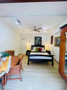 a bedroom with a bed and a table at Karinya in Clifton Beach