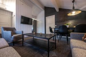 a living room with a table and chairs at Bruna Byn in Sälen