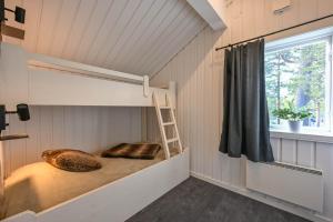 a room with a bunk bed with a ladder and a window at Bruna Byn in Sälen