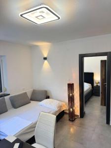 a living room with a bed and a couch at Paradise Villa Lopar in Lopar