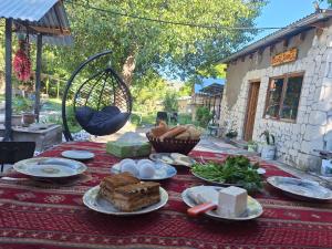 a table with plates of food on top of it at Davti Toon Guesthouse in Aghitu