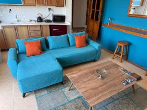 a blue couch in a living room with a table at BlueTown Fethiye in Fethiye +33 photos