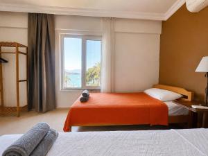 a hotel room with two beds and a window at BlueTown Fethiye in Fethiye