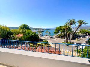 a balcony with a view of a street and the ocean at BlueTown Fethiye in Fethiye