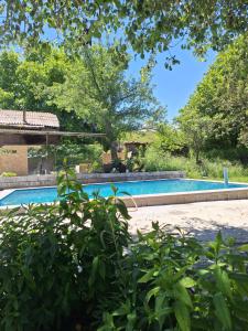 a swimming pool in the backyard of a house at Davti Toon Guesthouse in Aghitu