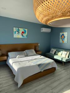 a bedroom with a large bed and a couch at Ocean's Heaven in Ensenada +15 photos