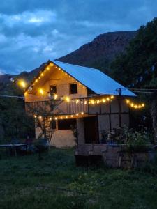 a house with lights on it in a field at Davti Toon Guesthouse in Aghitu