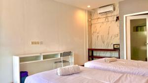 a room with two beds and a mirror at Villa PhyPhy in Gili Trawangan