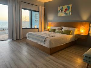a bedroom with a bed with two lamps and a window at Ocean's Heaven in Ensenada