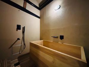 a bathroom with a wooden bath tub in a room at La Terra Hirasawa in Shiojiri