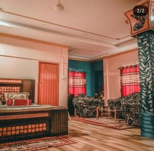 a bedroom with a bed and a couch at Madhuban Resort in Silchar