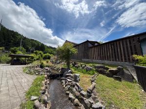 a bunch of rocks in a yard next to a building at La Terra Hirasawa in Shiojiri