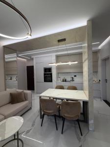 a kitchen and living room with a table and chairs at Merxhan`S Apartment in Golem