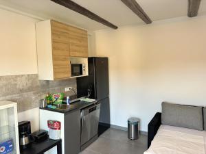 a small kitchen with a sink and a refrigerator at Paradise Villa Lopar in Lopar