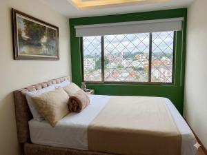 a bedroom with a large bed and a window at Hotel Iam Armenia Quindio in Armenia +6 photos