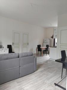 a living room with a couch and a table at Gîte Le 500 in Mayres