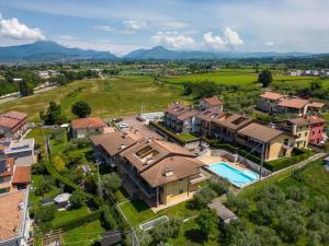 an aerial view of a house with a swimming pool at Snug Holiday Home in Lazise with Heating, near Lake Garda in Lazise +32 photos