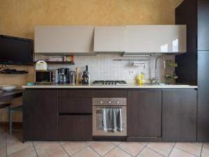 a kitchen with a stove top oven next to a sink at Snug Holiday Home in Lazise with Heating, near Lake Garda in Lazise