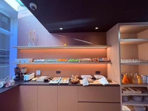 a kitchen with a counter with some food on it at Parkhotel Gent Centrum in Ghent