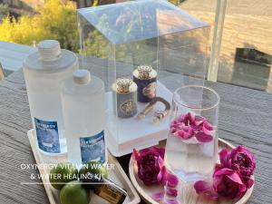 a table with a bottle of water and flowers on it at The Hive Chiang Mai Hotel in Chiang Mai +81 photos